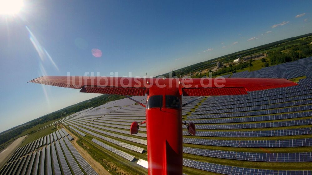 Luftaufnahme Werneuchen - Cessna 172 D-EGYC im Tiefflug über Solarfeldern des Flugplatzes in Werneuchen im Bundesland Brandenburg