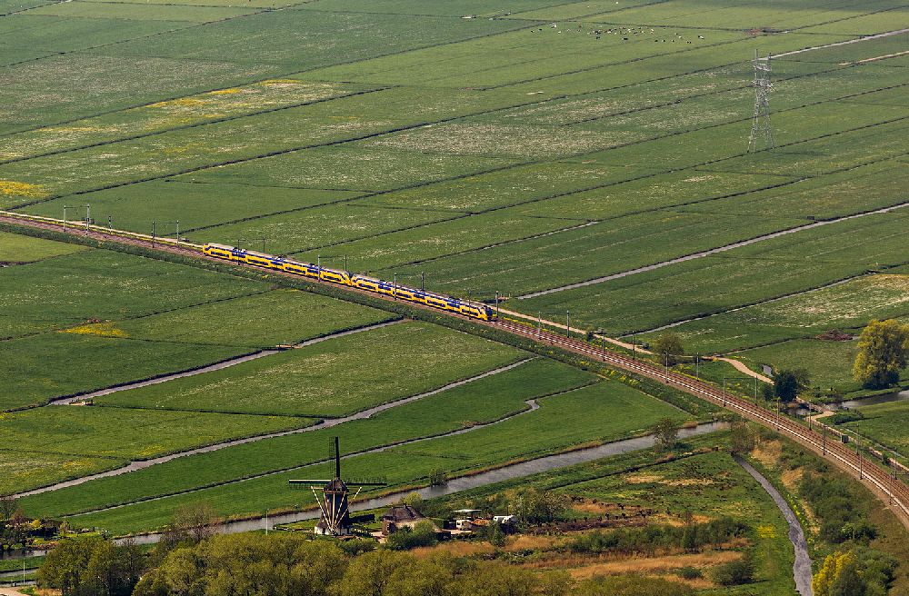 Naarden aus der Vogelperspektive: Regional- Zug Strecke in Feld- Landschaft mit Bewässerungsgräben bei Naarden in Nordholland - Niederlanden