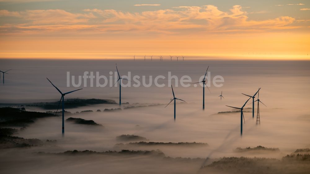 Luftbild Winsen (Luhe) - Wetterbedingt in eine Nebel- Schicht eingebettete Windenergieanlagen bei Sonnenaufgang in Winsen (Luhe) im Bundesland Niedersachsen, Deutschland