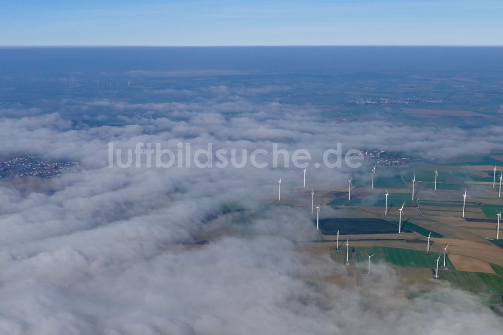Warburg von oben - Wetterbedingt in eine Nebel- Schicht eingebettete Windenergieanlagen auf einem Feld in Warburg im Bundesland Nordrhein-Westfalen, Deutschland